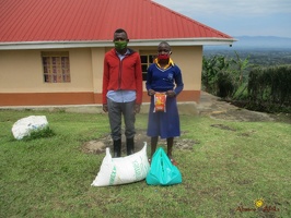 Muhindo Joan's family with their food package (1)
