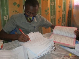 Teacher Byaruhanga Ronald marking home study work (5)