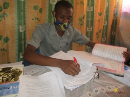 Teacher Byaruhanga Ronald marking home study work (6)