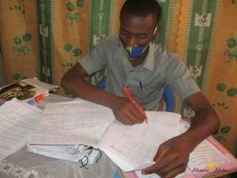 Teacher Byaruhanga Ronald marking home study work (10)