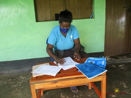 Teacher Tuhaise Goretti marking her pupils home study work (3)